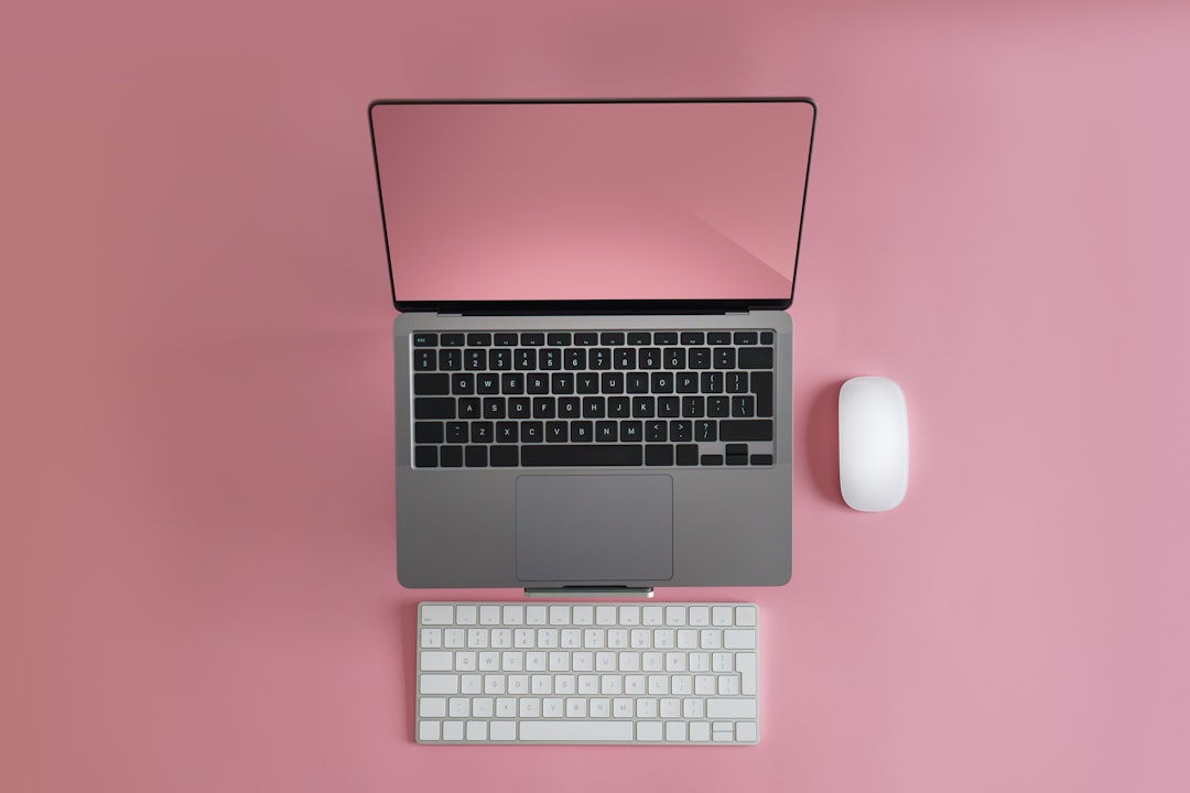 a laptop computer sitting on top of a white keyboard