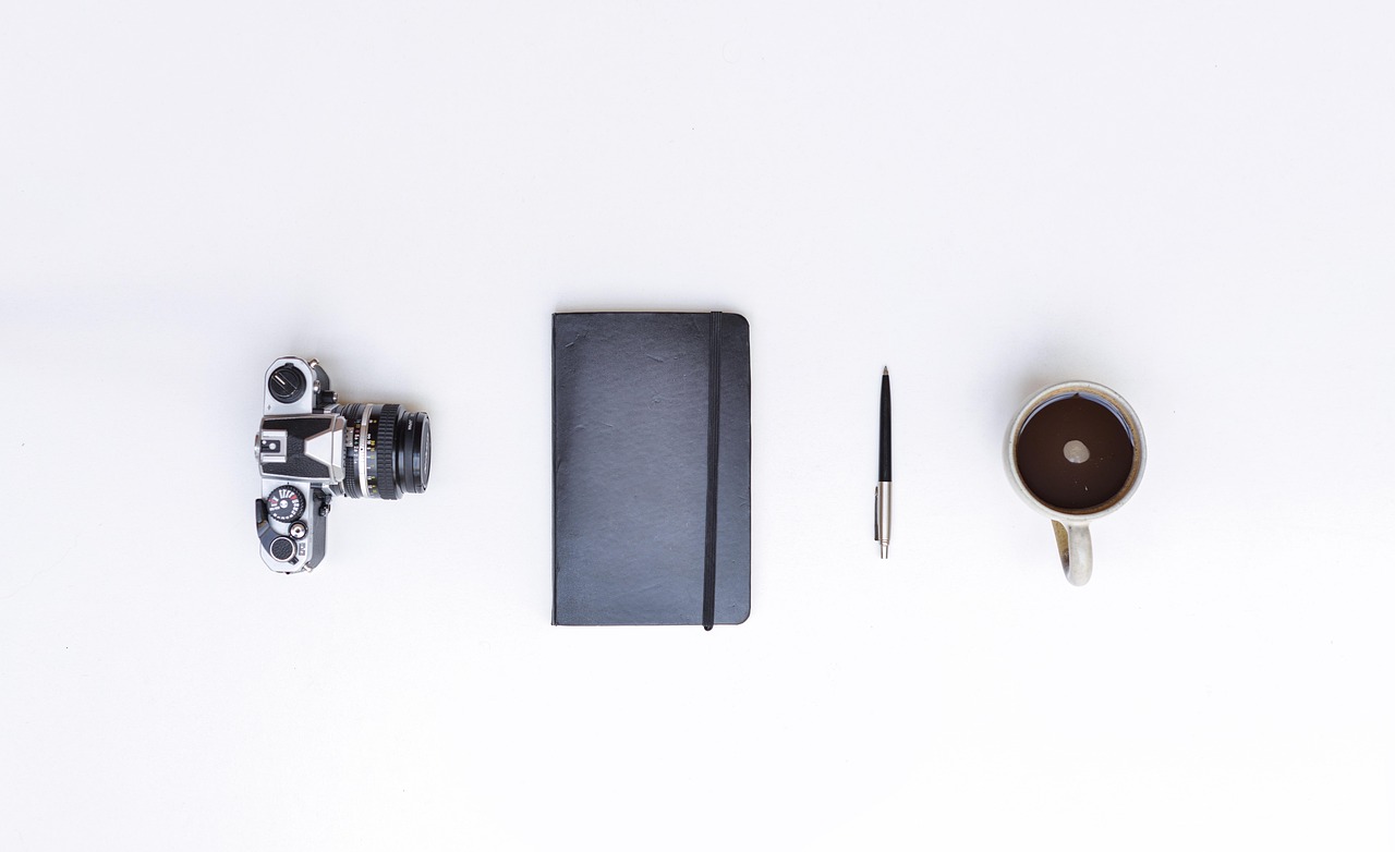 still life, camera, notebook, pen, cup, mug, coffee, desk, coffee cup, neat, tidy, clean, organized,